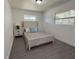 Bedroom with a floral pattern comforter, wood-look floors, and two windows providing natural light at 4128 Durant St, Port Charlotte, FL 33948