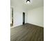 This bedroom features new laminate flooring and a minimalist aesthetic at 4128 Durant St, Port Charlotte, FL 33948