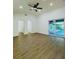 Bright bedroom with wood floors, white walls, ceiling fan, and access to the pool area at 4128 Durant St, Port Charlotte, FL 33948