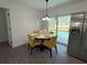 Dining area with views of the pool and backyard with sliding glass doors and stainless steel refrigerator at 4128 Durant St, Port Charlotte, FL 33948