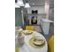 Bright eat-in kitchen featuring stainless steel appliances, white cabinets, quartz countertops, and a marble table at 4128 Durant St, Port Charlotte, FL 33948