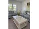 Bright living room featuring two couches with throw pillows and a glass top coffee table at 4128 Durant St, Port Charlotte, FL 33948