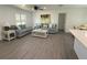 Bright and open living room featuring modern furnishings, sleek flooring, and ample natural light at 4128 Durant St, Port Charlotte, FL 33948