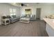 Living room with wood-look flooring, a ceiling fan, and two couches with throw pillows at 4128 Durant St, Port Charlotte, FL 33948