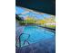 Inviting in-ground pool with screened enclosure, tiled surround, ladder access, and clear blue water at 4128 Durant St, Port Charlotte, FL 33948
