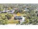 Aerial view of single Gathering home featuring well-manicured lawn surrounded by lush trees at 4175 Horseshoe Ave, North Port, FL 34286