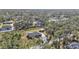 An aerial view of the house and neighborhood showing lots of trees at 4175 Horseshoe Ave, North Port, FL 34286