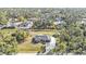 Aerial view of single Gathering home featuring well-manicured lawn surrounded by lush trees at 4175 Horseshoe Ave, North Port, FL 34286