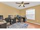 Home office with a ceiling fan, window with blinds, hardwood floors, and multiple work stations at 4175 Horseshoe Ave, North Port, FL 34286