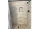 Modern walk-in shower featuring decorative tile, matte black hardware, and a recessed shower caddy at 4175 Horseshoe Ave, North Port, FL 34286