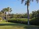 Waterfront backyard with swaying palm trees, lush greenery, and boat dock at 4254 Bur St, Port Charlotte, FL 33948