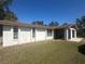 This home features a well-maintained backyard lawn providing a peaceful outdoor space and a covered walkway at 432 Olivia Rd, Venice, FL 34293