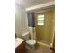 Bathroom showcasing a tiled walk-in shower, commode, vanity, and natural light, highlighting its functionality at 432 Olivia Rd, Venice, FL 34293