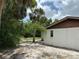 Exterior view of home showing the side of the house with trees and green space at 432 Olivia Rd, Venice, FL 34293