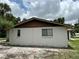 Side view of the property featuring a simple exterior with a brown trim and white exterior at 432 Olivia Rd, Venice, FL 34293