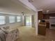 Bright living room featuring multiple windows, seamlessly connected to the kitchen area at 432 Olivia Rd, Venice, FL 34293