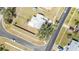 Aerial view of a single-Gathering home showcasing the full property, including the yard, landscaping, and surrounding neighborhood at 5909 Talbrook Rd, North Port, FL 34287