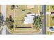 Aerial view of a single-Gathering home showcasing the full property, including the yard, landscaping, and surrounding neighborhood at 5909 Talbrook Rd, North Port, FL 34287