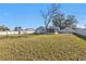 Wide shot of a backyard with a fence, shed, and the back of the house at 5909 Talbrook Rd, North Port, FL 34287
