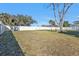 A fenced in yard with a large grassy area and mature trees at 5909 Talbrook Rd, North Port, FL 34287