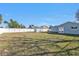 Backyard with a grassy area, vinyl fence, shed, and the back of the house at 5909 Talbrook Rd, North Port, FL 34287