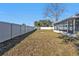 Spacious backyard featuring a white privacy fence and a screened in porch at 5909 Talbrook Rd, North Port, FL 34287