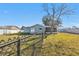 Large, grassy backyard featuring a black chain link fence at 5909 Talbrook Rd, North Port, FL 34287