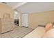 Neutral bedroom with tiled floor with a closet, a dresser, and adjacent laundry room with machines at 5909 Talbrook Rd, North Port, FL 34287