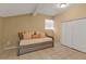 Cozy bedroom features neutral walls, tile floors, and a comfortable daybed with closet at 5909 Talbrook Rd, North Port, FL 34287