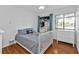 Charming bedroom with hardwood floors and a window. Features a closet with custom shelving at 5909 Talbrook Rd, North Port, FL 34287