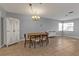 Dining area featuring tile floors, modern lighting, and table with seating at 5909 Talbrook Rd, North Port, FL 34287