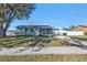 Charming single-story home with a well-maintained lawn and cozy front porch at 5909 Talbrook Rd, North Port, FL 34287