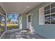 Enclosed front porch with a white front door and window at 5909 Talbrook Rd, North Port, FL 34287