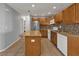 Bright kitchen featuring a center island, granite countertops, stainless steel refrigerator, and tiled backsplash at 5909 Talbrook Rd, North Port, FL 34287