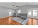 Spacious living room with wood floors, vaulted ceiling, leather sofa, and a ceiling fan at 5909 Talbrook Rd, North Port, FL 34287