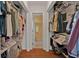 Spacious walk-in closet with ample shelving and hanging space, leading into an en-suite bathroom at 5909 Talbrook Rd, North Port, FL 34287