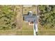 This is an aerial view of a house and lot with RV parked on driveway, surrounded by trees at 11338 Willmington Blvd, Port Charlotte, FL 33981