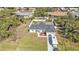 This is an aerial view of a house and lot with RV parked on driveway, surrounded by trees at 11338 Willmington Blvd, Port Charlotte, FL 33981