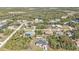 This is an aerial view of the community, with trees surrounding the neighborhood, and a lake in the background at 11338 Willmington Blvd, Port Charlotte, FL 33981