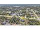 An aerial view shows the location of the home in a neighborhood surrounded by trees and roads at 11338 Willmington Blvd, Port Charlotte, FL 33981