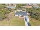 This is an aerial view of a house and lot with RV parked on driveway, surrounded by trees at 11338 Willmington Blvd, Port Charlotte, FL 33981