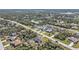 This is an aerial view of the neighborhood, with trees surrounding the community, and a lake in the background at 11338 Willmington Blvd, Port Charlotte, FL 33981