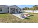 Patio with lawn chairs, a small outdoor carpet and a table at 11338 Willmington Blvd, Port Charlotte, FL 33981