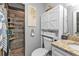 Bathroom featuring a granite vanity, white cabinetry, and a tiled shower at 11338 Willmington Blvd, Port Charlotte, FL 33981