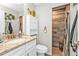 Bathroom showcasing a stone countertop vanity and walk-in shower with tile surround at 11338 Willmington Blvd, Port Charlotte, FL 33981