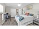Bedroom with gray floors, white closet, door, colorful accent pillows, and a small seating area at 11338 Willmington Blvd, Port Charlotte, FL 33981