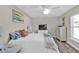 Bright bedroom featuring a ceiling fan, white furniture, and stylish decor at 11338 Willmington Blvd, Port Charlotte, FL 33981