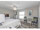 Bright bedroom with neutral colors and a sitting area by the window at 11338 Willmington Blvd, Port Charlotte, FL 33981