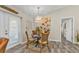 Cozy dining area featuring a round table, wicker chairs, and decorative lighting fixture at 11338 Willmington Blvd, Port Charlotte, FL 33981