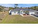 A charming single-story home featuring a well-manicured lawn and inviting front porch with cozy seating at 11338 Willmington Blvd, Port Charlotte, FL 33981